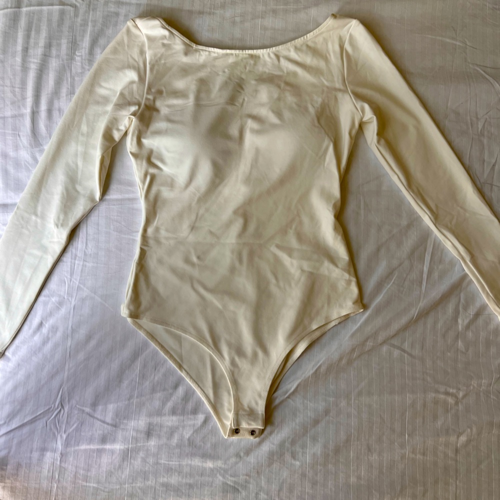 New with tag bodysuit. White. Long sleeve. Padded.